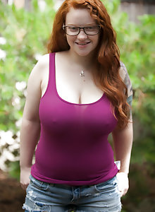 Glasses wearing big tits redhead Kaycee Barnes flashing her boobs in the woods