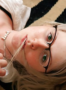 Cute and fun nerd Nadia writhing naked on her bed in glasses