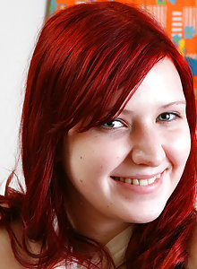 Scarlet haired schoolgirl Krystin stripping and smiling in her bedroom